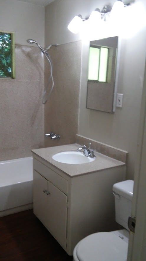 a bathroom with a sink toilet and a mirror